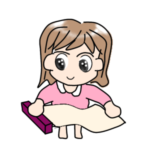 クッキングシートを引き出し、ジグソーパズルの下に敷こうとしている女性。手軽さを試している様子。